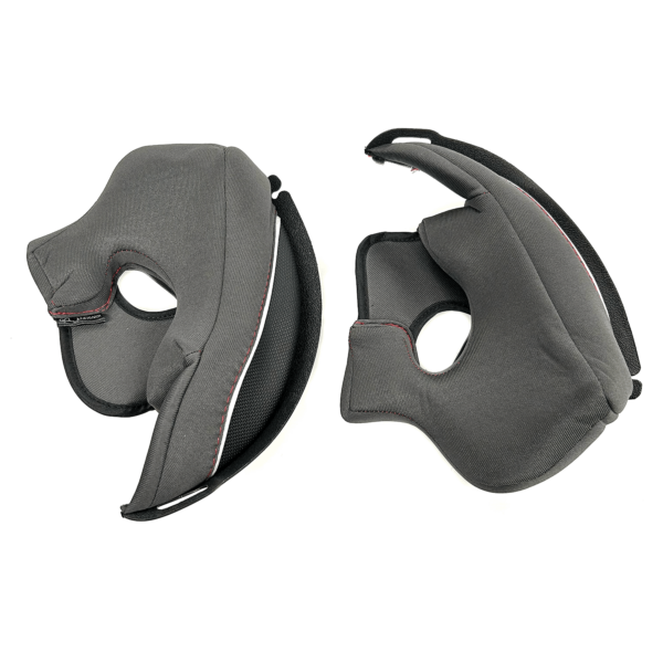 A pair of black and gray removable cheek pads with cutouts for a bike or motorcycle helmet. The pads feature white and red accents along the seams and have a textured surface for added comfort and stability.